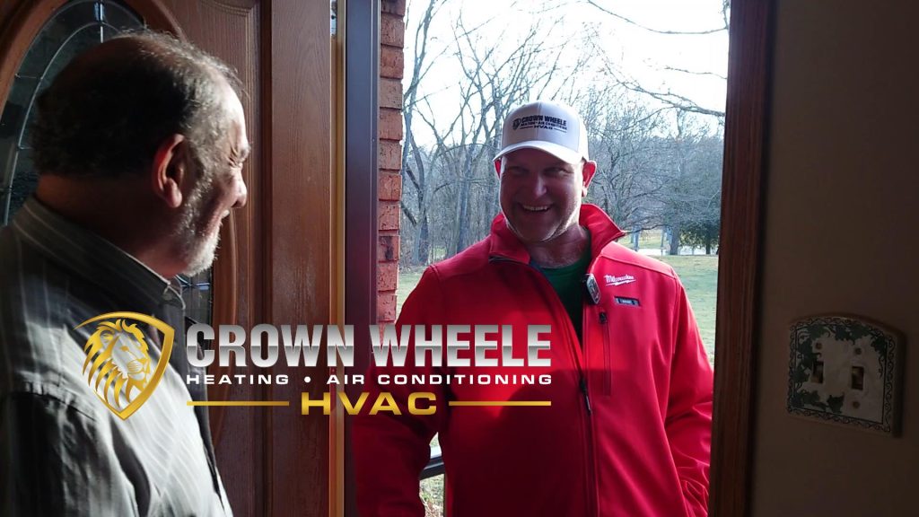 Crown Wheele technician greeting a Valparaiso homeowner at the front door