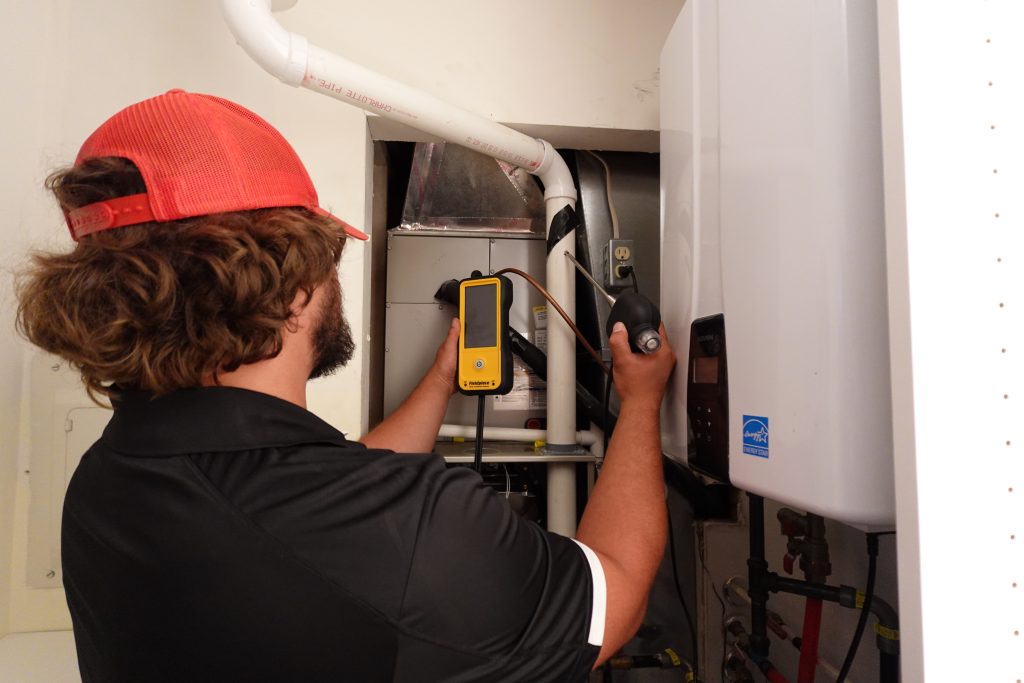 Crown Wheele technician testing a home heating system in Valparaiso